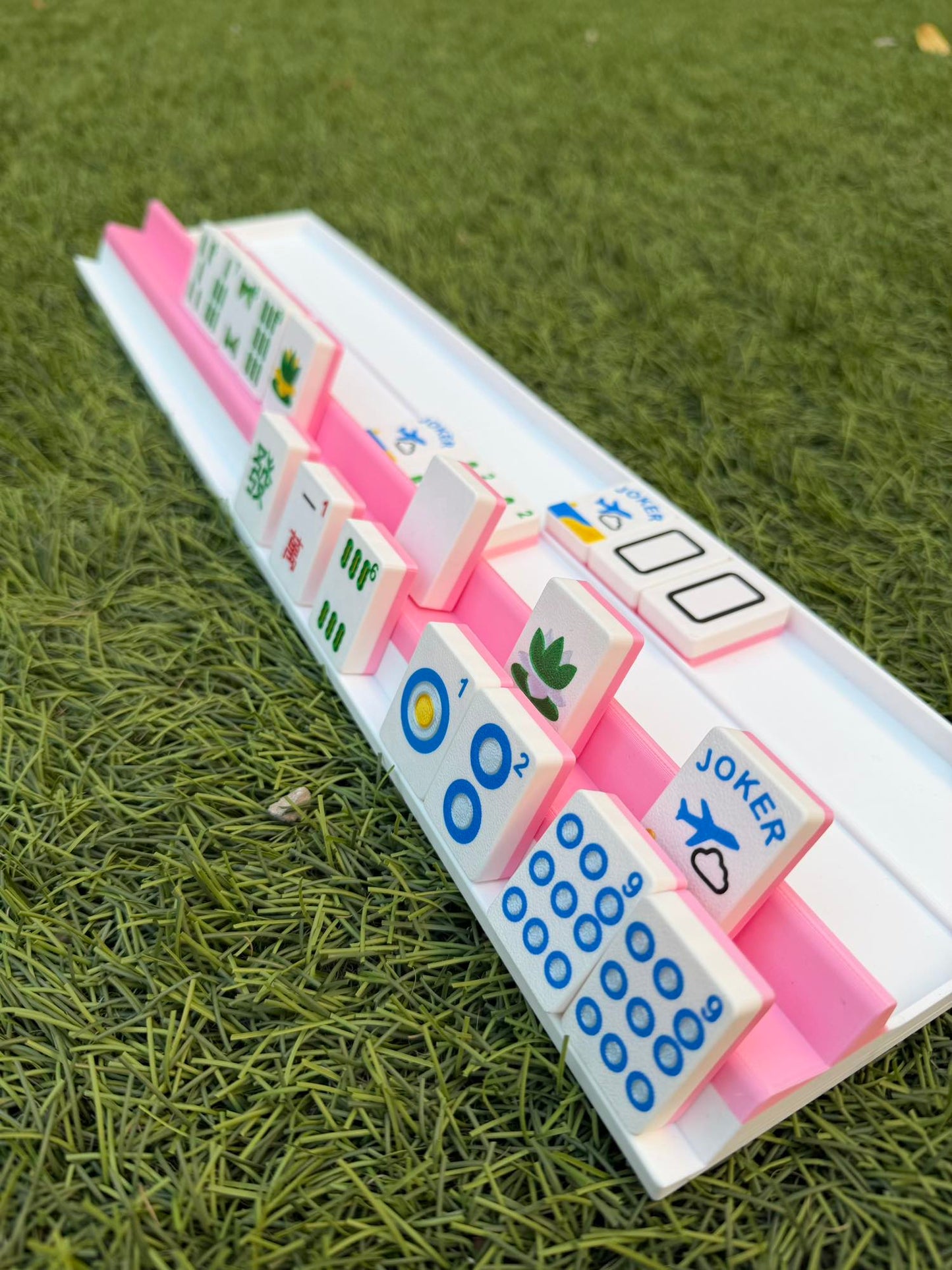 Detail view of a Siamese travel rack holding 28 tiles, showing the compact 3D-printed design.