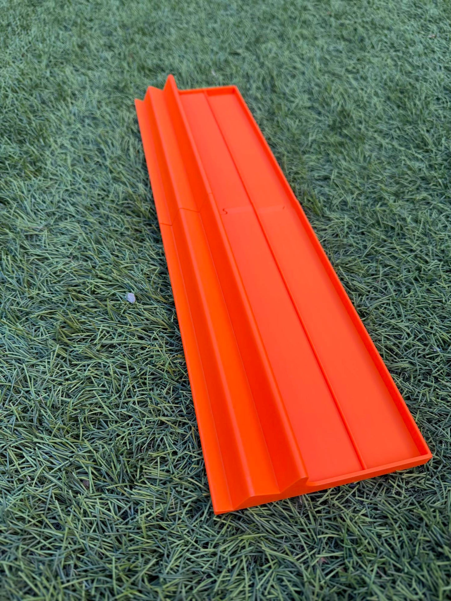 A 3D-printed Siamese Mahjong rack in bright orange with triple-tier tile slots