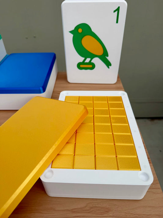 Yellow Mahjong Tiles in a container with a card featuring a green bird on a gray background