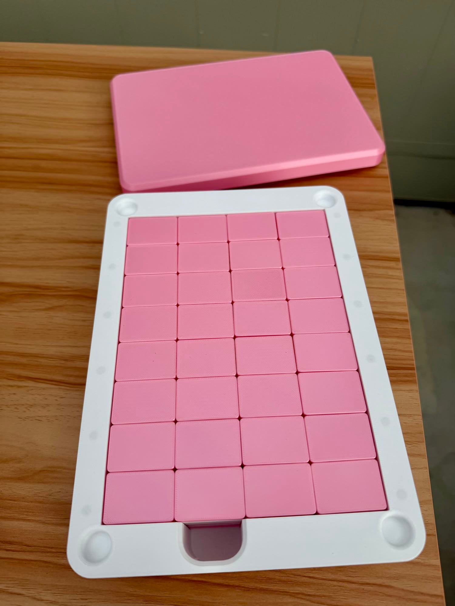 Pink Mahjong Tile Box with a pink lid on a wooden surface