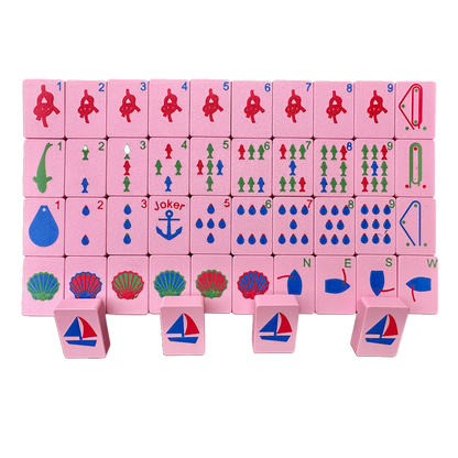 Set of pink mahjong travel tiles with a nautical theme.