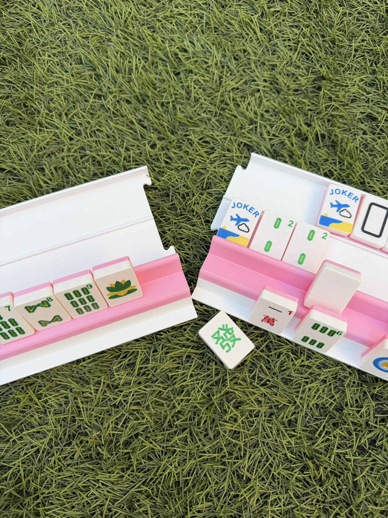 Two sections of a pink and white Siamese rack pulled apart to show the travel-friendly modular design.