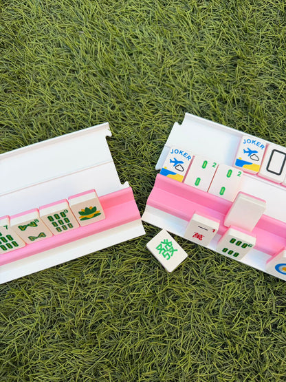 Two sections of a pink and white Siamese rack pulled apart to show the travel-friendly modular design.