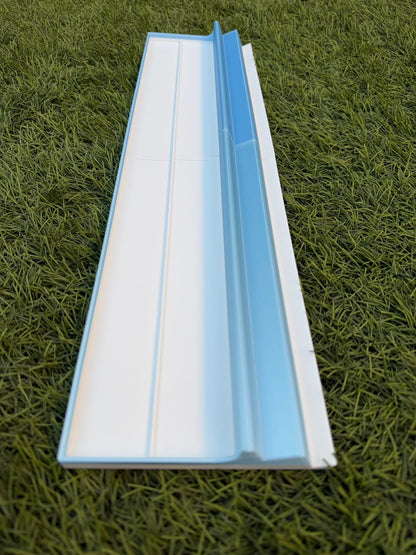 A long, light blue and white travel rack designed for Siamese Mahjong gameplay