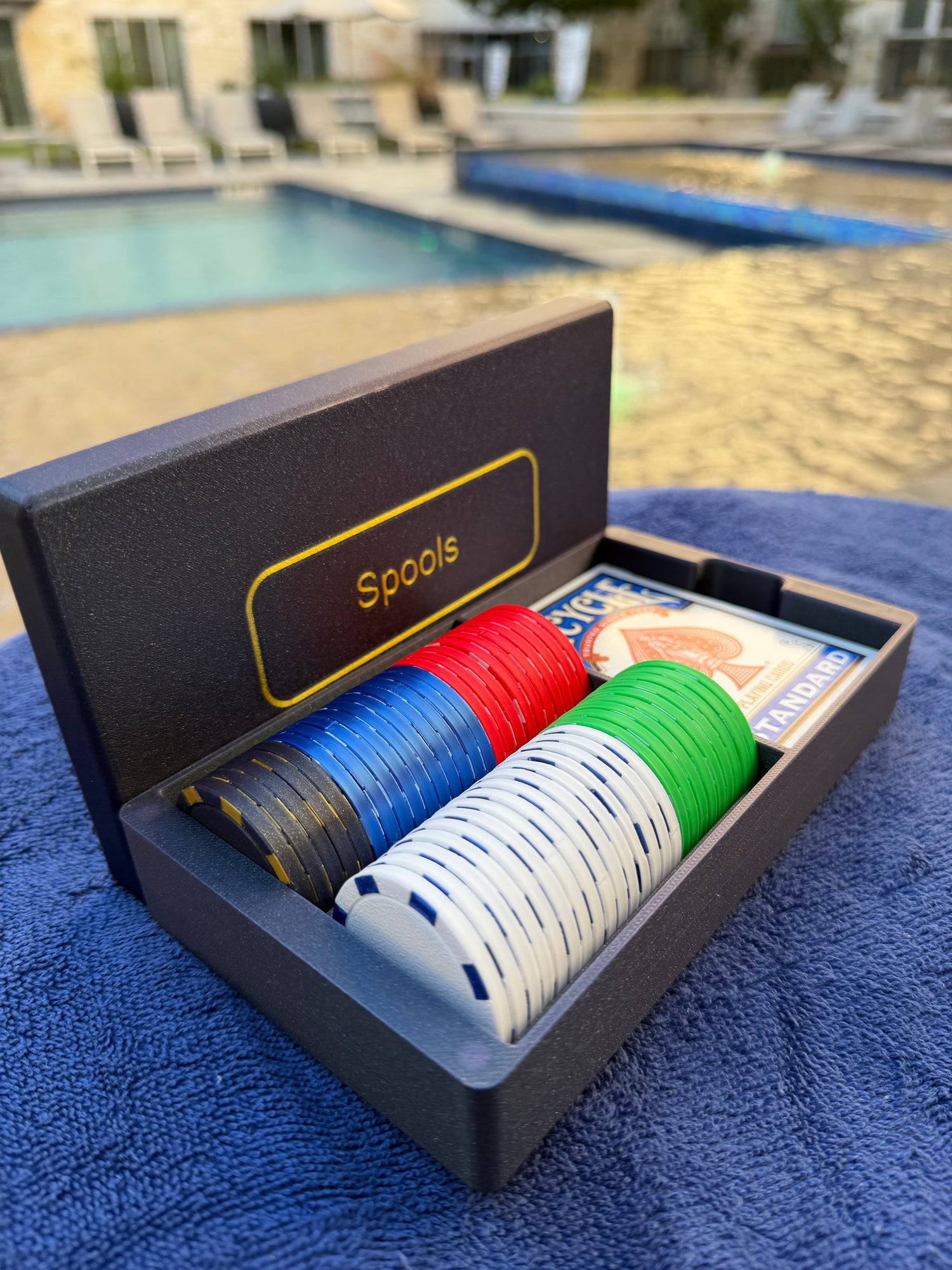 Full-size travel poker chip set by Spools with lightweight casino-style chips in a compact magnetic display case, designed for portable poker play.