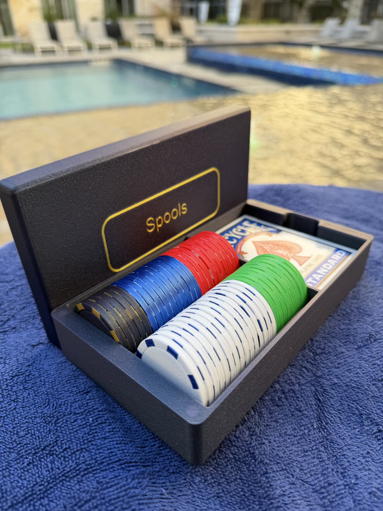 Close-up of Spools lightweight poker chips in multiple colors showing textured surface and edge detail.
