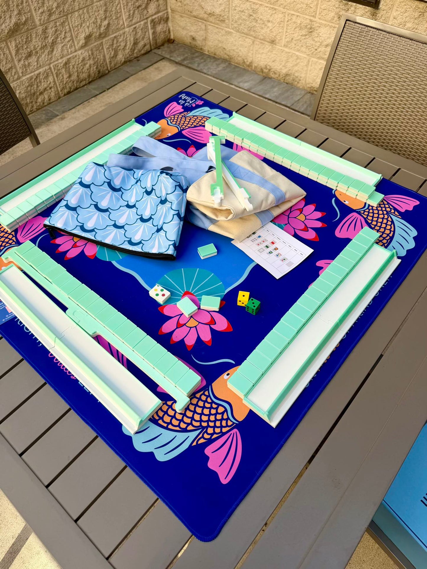 Spools Pickleball travel mahjong set with green racks and lightweight tiles arranged on a pickleball-themed playing mat.