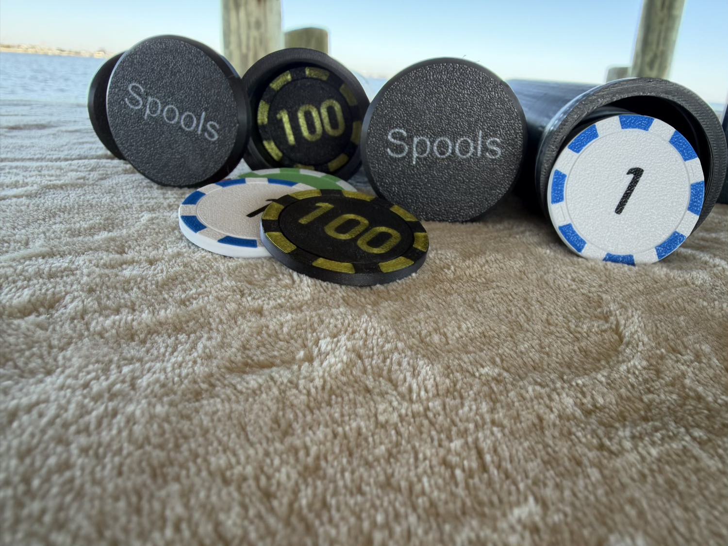Close-up of Spools lightweight poker chips showing chip faces, colors, and printed values