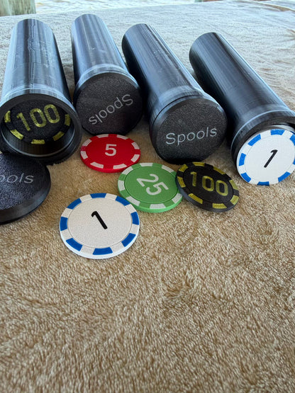 Spools lightweight poker chips grouped together showing different colors and denominations.
