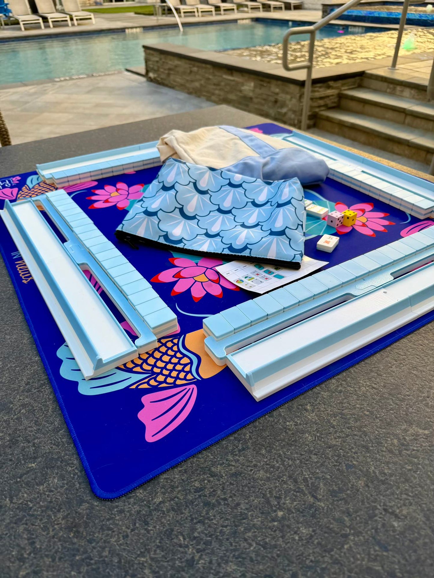 Close-up of Spools pool mahjong floating tiles showing symbols, colors, and textured surface.
