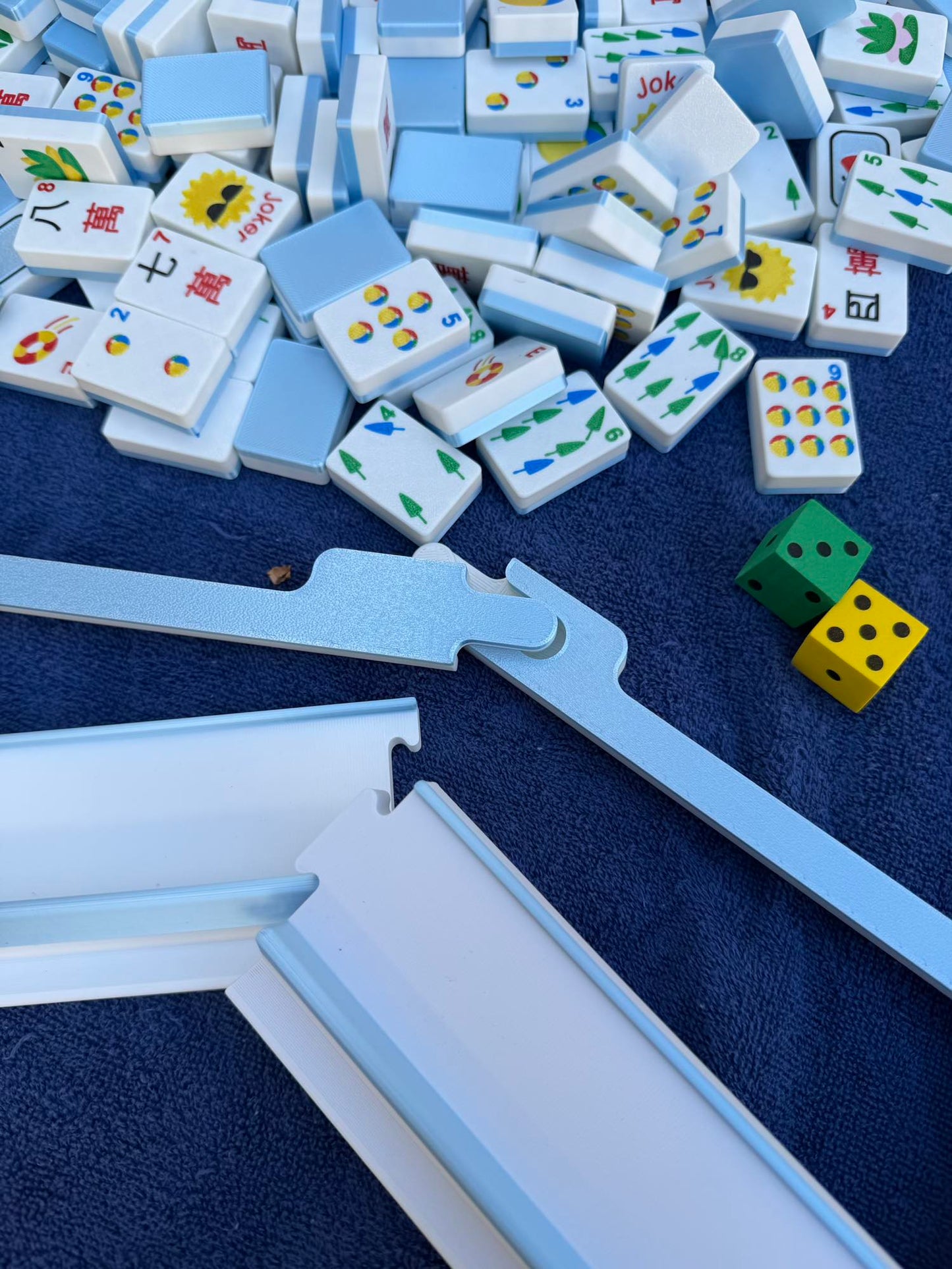 Spools pool mahjong floating tiles poured from a carrying bag, designed to float on water.
