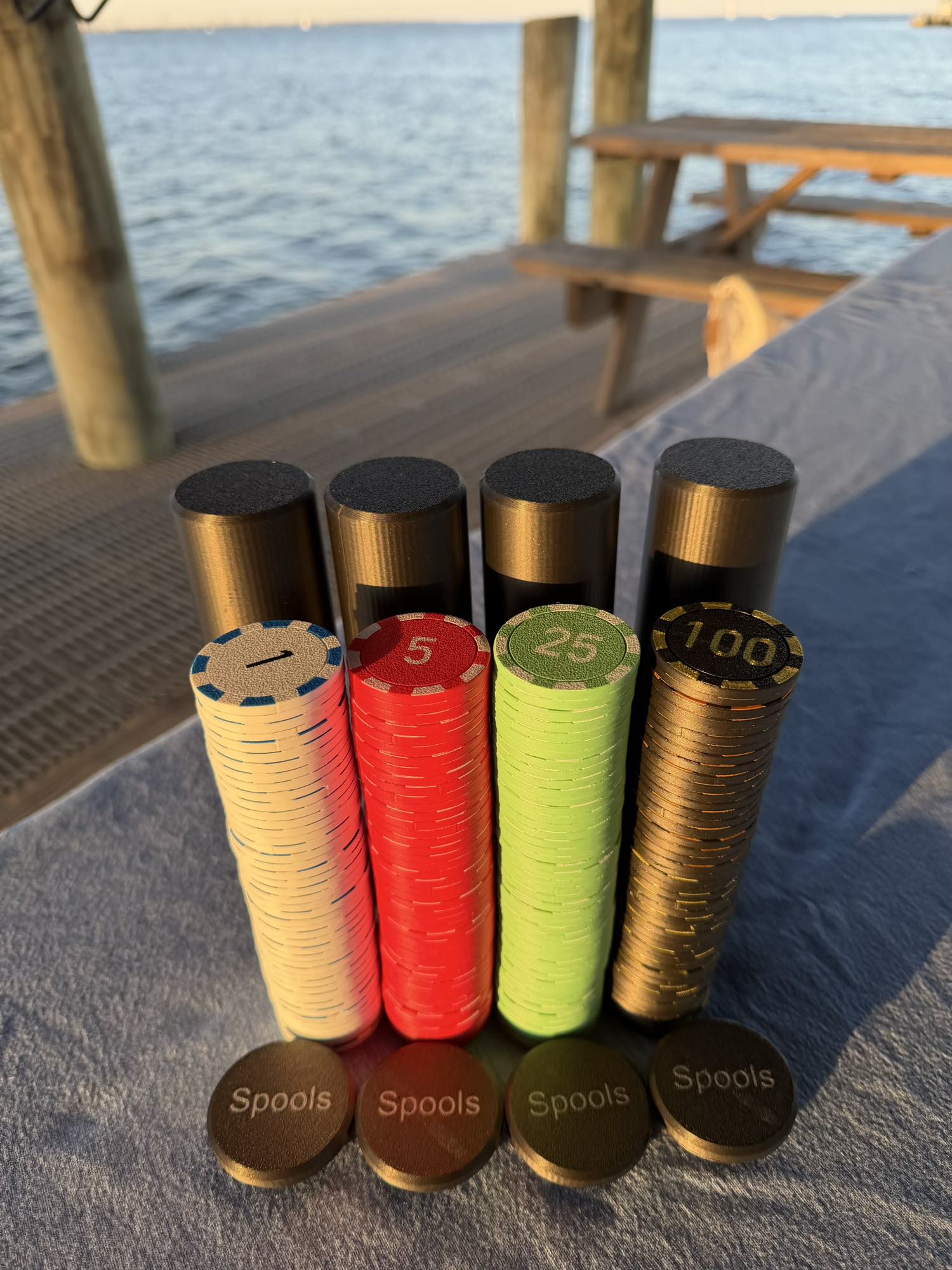 Spools travel poker set showing stacked lightweight poker chips next to compact black carrying cases.