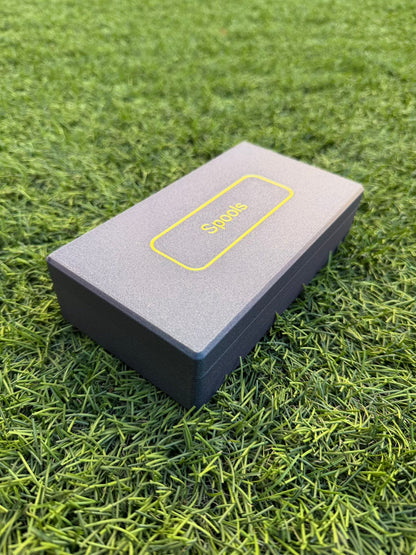 Spools travel poker set closed in a slim gray carrying case with yellow logo, shown on green grass.