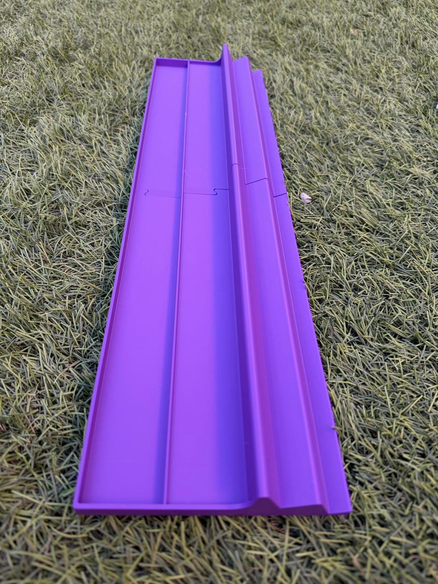 A 3D-printed triple-tier Siamese Mahjong rack in vibrant purple, resting on grass.