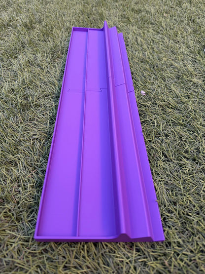 A 3D-printed triple-tier Two Player Mahjong rack in vibrant purple, resting on grass.