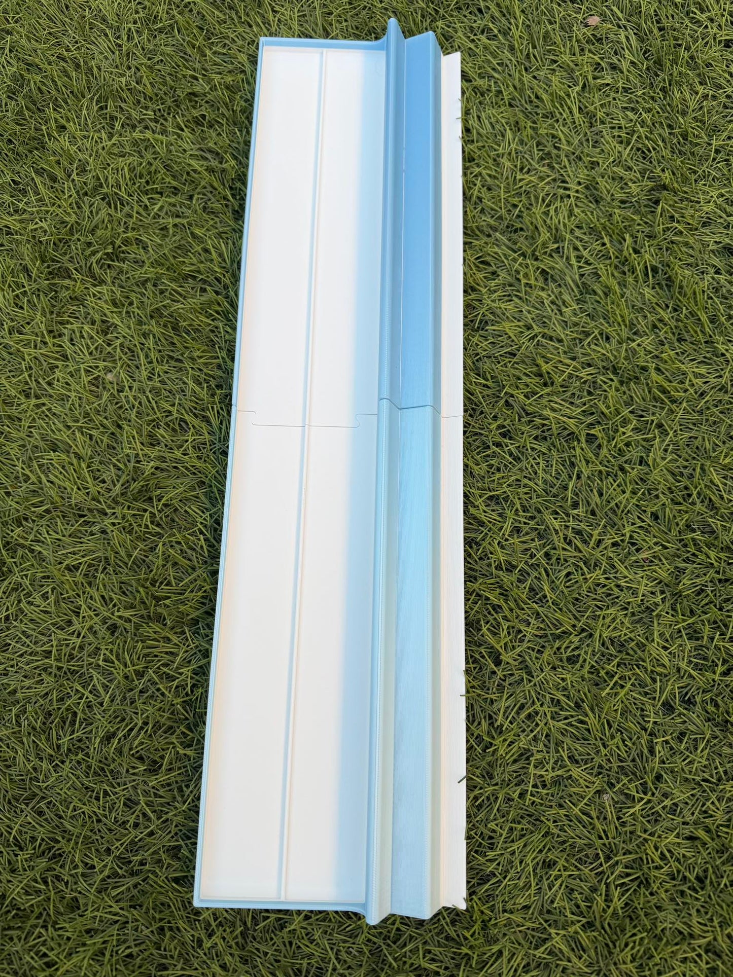 A single long-form travel Mahjong rack in white with a light blue divider rail.