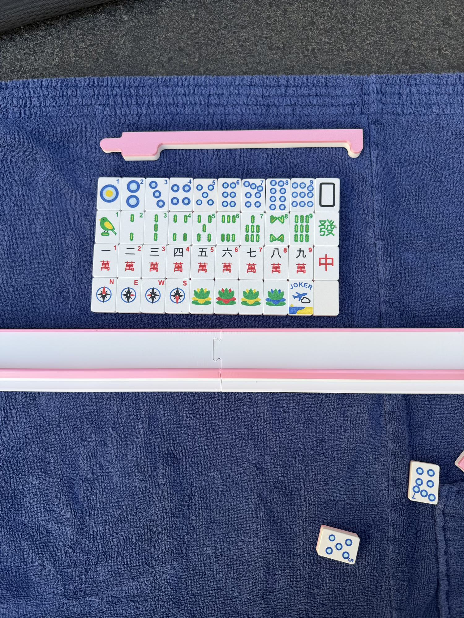 Compass Travel Mahjong tiles arranged in a full wall layout, featuring compass winds, dots, bams, craks, flowers, and jokers.